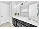 Double vanity bathroom with dark cabinets and a large mirror at 2599 Nouveau Way, Kissimmee, FL 34741