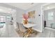 Elegant dining room with a white table, gold chairs, and decorative accents at 2599 Nouveau Way, Kissimmee, FL 34741