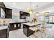 Modern kitchen featuring dark cabinetry, stainless steel appliances, and an island at 2599 Nouveau Way, Kissimmee, FL 34741