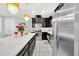Bright kitchen with stainless steel appliances and dark cabinetry at 2599 Nouveau Way, Kissimmee, FL 34741