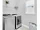 Convenient laundry room with washer, dryer, and overhead shelving at 2599 Nouveau Way, Kissimmee, FL 34741