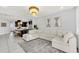 Open concept living area with sectional sofa and view into the kitchen and dining area at 2599 Nouveau Way, Kissimmee, FL 34741