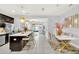 Open concept kitchen with island, stainless steel appliances, and dark cabinetry at 2599 Nouveau Way, Kissimmee, FL 34741