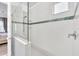 Walk-in shower with glass enclosure and tiled walls at 2599 Nouveau Way, Kissimmee, FL 34741