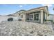 Large backyard features a patio, screened enclosure, and grill area at 2599 Nouveau Way, Kissimmee, FL 34741
