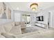 Spacious living room featuring a large sectional sofa, a chandelier, and access to a patio at 2599 Nouveau Way, Kissimmee, FL 34741