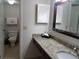 Clean bathroom with granite vanity and a toilet at 6336 Parc Corniche Dr # 3303, Orlando, FL 32821