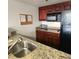 Well-equipped kitchen featuring granite countertops and modern appliances at 6336 Parc Corniche Dr # 3303, Orlando, FL 32821