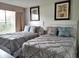 Bright bedroom with two twin beds and ample natural light at 6336 Parc Corniche Dr # 3303, Orlando, FL 32821