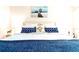 Relaxing bedroom with white and blue bedding, matching nightstands, and artwork at 2601 Gala S Rd # 107, Kissimmee, FL 34746