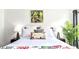 Bright bedroom with white bedding, tropical-themed decor, and matching nightstands at 2601 Gala S Rd # 107, Kissimmee, FL 34746