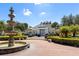 Clubhouse exterior with a fountain and brick paved driveway at 2601 Gala S Rd # 107, Kissimmee, FL 34746