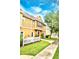 Charming two-story home with yellow siding, white picket fence, and landscaped yard at 2601 Gala S Rd # 107, Kissimmee, FL 34746