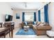 Spacious living room with a large sectional, dining area, and blue patterned rug at 2601 Gala S Rd # 107, Kissimmee, FL 34746
