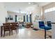 Open living room with a sectional sofa, dining table, and blue accent chairs at 2601 Gala S Rd # 107, Kissimmee, FL 34746