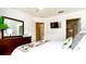 Comfortable main bedroom with a TV, a dresser, and access to a private bathroom at 2601 Gala S Rd # 107, Kissimmee, FL 34746
