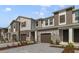 Modern townhome with gray siding, two-car garage, and landscaped front at 707 Southern Edge Way, Sanford, FL 32771