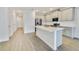 Modern kitchen with gray cabinets and a large quartz island at 707 Southern Edge Way, Sanford, FL 32771