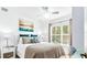 Bedroom with a queen bed, teal pillows, and neutral color scheme at 2601 Gala S Rd # 107, Kissimmee, FL 34746