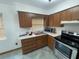 Kitchen with wood cabinets, stainless steel appliances and tiled floors at 2815 N Leavitt Ave, Orange City, FL 32763