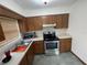 Kitchen with wood cabinets, stainless steel appliances and tiled floors at 2815 N Leavitt Ave, Orange City, FL 32763