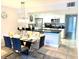 Dining area with glass table and modern gray chairs at 5009 Laguna Bay Cir # 41, Kissimmee, FL 34746