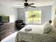 Main bedroom with king bed and view of backyard at 5009 Laguna Bay Cir # 41, Kissimmee, FL 34746