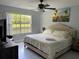 King-size bed, water view, and ceiling fan in this tranquil bedroom at 5009 Laguna Bay Cir # 41, Kissimmee, FL 34746