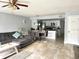 Open concept living and kitchen area with tile floors and gray sectional sofa at 5009 Laguna Bay Cir # 41, Kissimmee, FL 34746