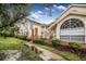 Two-story condo building with brick accents and lush landscaping at 5009 Laguna Bay Cir # 41, Kissimmee, FL 34746