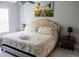 King-size bed, coastal art, and ceiling fan at 5009 Laguna Bay Cir # 41, Kissimmee, FL 34746