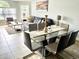 Bright dining area with glass table and seating for four, adjacent to living room at 5009 Laguna Bay Cir # 41, Kissimmee, FL 34746