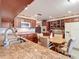 Kitchen boasts granite countertops, wood cabinets, and breakfast nook at 4711 County Road 134, Wildwood, FL 34785