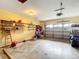 Spacious garage with overhead storage and room for golf cart at 4711 County Road 134, Wildwood, FL 34785