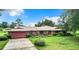 Brick ranch house with attached garage and yard at 4711 County Road 134, Wildwood, FL 34785