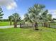 Landscaped front yard with palm trees and brick columns at 4711 County Road 134, Wildwood, FL 34785