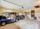 Attached garage with extra storage space and golf cart at 4711 County Road 134, Wildwood, FL 34785