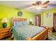 Bedroom with wood furniture, ceiling fan, and large bed at 4711 County Road 134, Wildwood, FL 34785