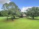 Ranch style home nestled on a spacious lot with lush greenery at 4711 County Road 134, Wildwood, FL 34785