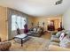 Comfortable living room with two sofas and a view into the dining room at 4711 County Road 134, Wildwood, FL 34785