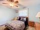 Cozy bedroom with neutral color walls and ceiling fan at 4711 County Road 134, Wildwood, FL 34785