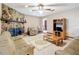 Living room showcasing a stone fireplace and tiled floors at 4711 County Road 134, Wildwood, FL 34785
