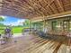 Spacious deck with a screened porch and backyard view at 4711 County Road 134, Wildwood, FL 34785