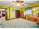 Bright bedroom with wood furniture and ceiling fan at 4711 County Road 134, Wildwood, FL 34785