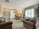 Spacious living room featuring comfortable seating and large windows at 4711 County Road 134, Wildwood, FL 34785
