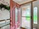 Inviting entryway with a red front door and sidelights at 4711 County Road 134, Wildwood, FL 34785