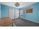 Blue bedroom with double doors and window at 16208 Magnolia Hill St, Clermont, FL 34714