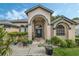 Attractive one-story house with a covered entryway, landscaping, and a neutral color palette at 16208 Magnolia Hill St, Clermont, FL 34714