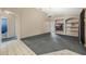 Living area with built-in shelving, a TV, and access to a bathroom at 16208 Magnolia Hill St, Clermont, FL 34714