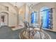 Small dining area with a glass-top table and four chairs, near the entryway at 16208 Magnolia Hill St, Clermont, FL 34714